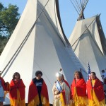 Native Americans in front of teepees